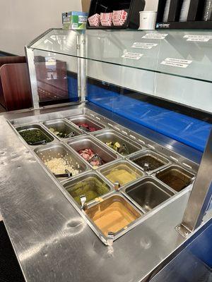 Salsa bar, clean and cold with many options