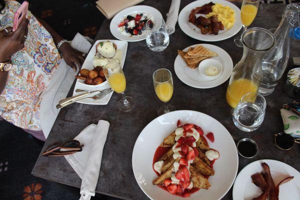 Left: eggs benedict & yogurt parfait; top: egg breakfast; bottom: strawberry cheesecake french toast (a special)