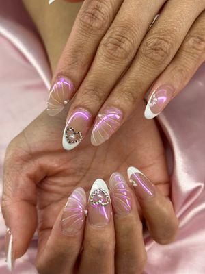 Coquette iridescent nails with white french tip and crystal heart gems