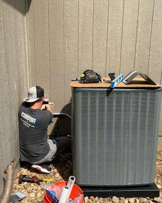 HVAC technician installing a new AC unit in Liberty, Missouri.