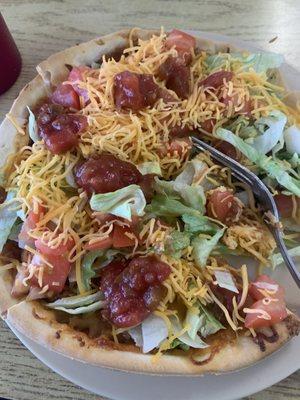 The personal size taco pizza  with salsa on top