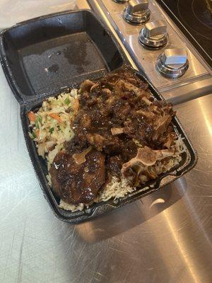 Generous portion of oxtail, rice, and cabbage.