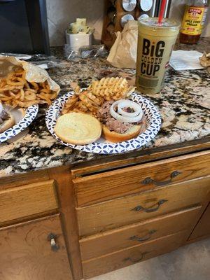 The number six brisket sandwich with waffle fries and a very large iced tea