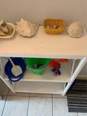 Shelf by front door was left with sand covered toys and literally sand all over the floor and shelf