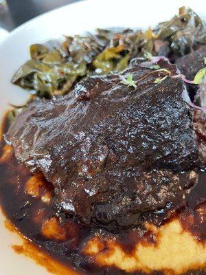 BBQ braised short rib with cheesy polenta and collard greens.