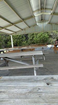 There are a bunch of picnic tables by the lot. Plenty of shade from the sun or shelter from rain.