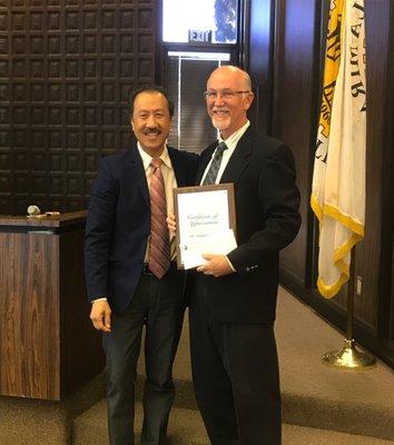 Dr. Smith being honored by La Mirada mayor, Mayor Ed Eng for his 17 years of service on the Community Services Foundation