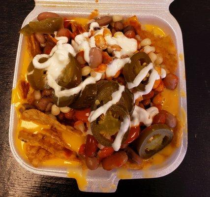 Nachos w/ Tostitos, beans, jalapenos, corn, sour cream.