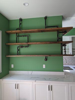 Recently installed shelves using 3/4 black iron pipe and discarded old floor joists.