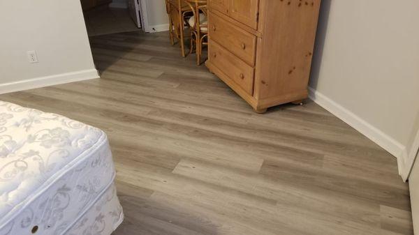 Vinyl plank flooring with quarter round installed