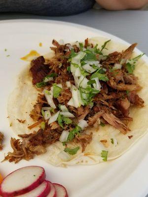 Carnitas taco on flour tortilla