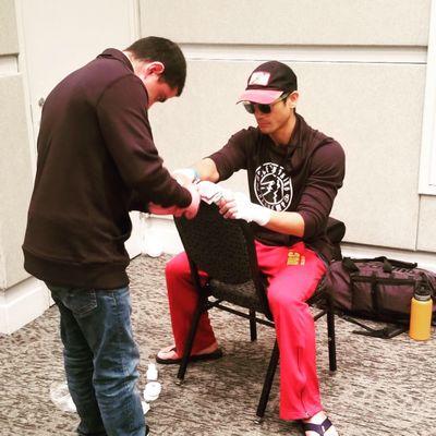 Coach Miguel wrapping me up before my fight