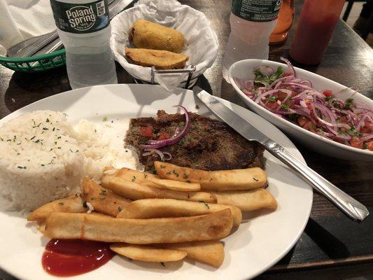 1/2 steak with rice and fries. Beef Empanadas in the background