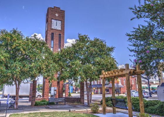 Strolling the quaint Simpsonville downtown, you will observe its striking clock tower, historic structures, and train tracks along Main St.