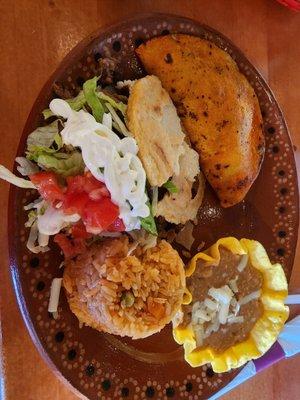 Combo with Mexican rice, refried beans, birria taco and a gordita with Carne asada.