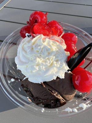 Dark chocolate and vanilla ice cream topped with whipped cream and cherries