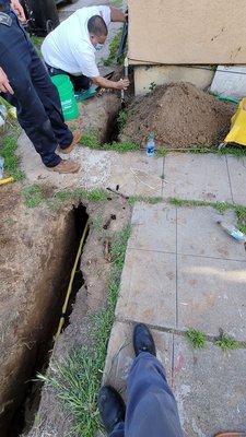 Ricardo finishing up installing a shut off to existing gas line before he pressure test the line and backfills the open trench.