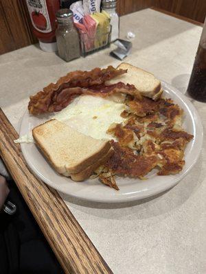 2 eggs over medium with 4 bacon strips, crispy home fries and white toast.