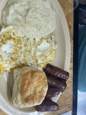 Breakfast sausage.,eggs and grits.