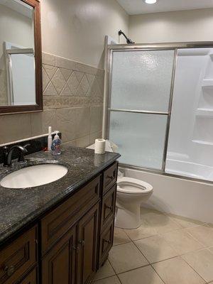 New tub and toilet and tile and paint in the bathroom enclosed a window and added new lighting.