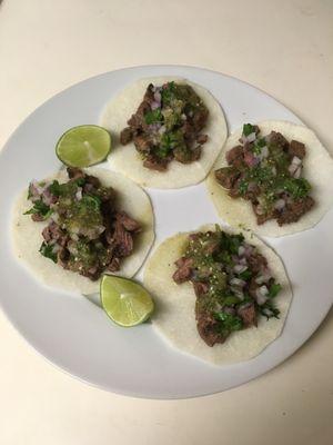 JICAMA TORTILLA  STEAK TACOS.

Topped with onions, cilantro, green sauce, and lime.