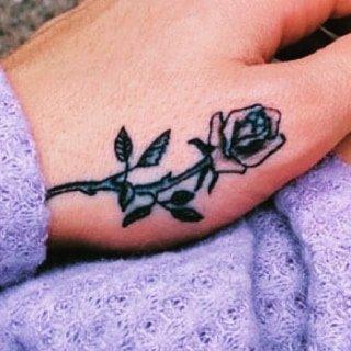 Tiny thumb tattoo