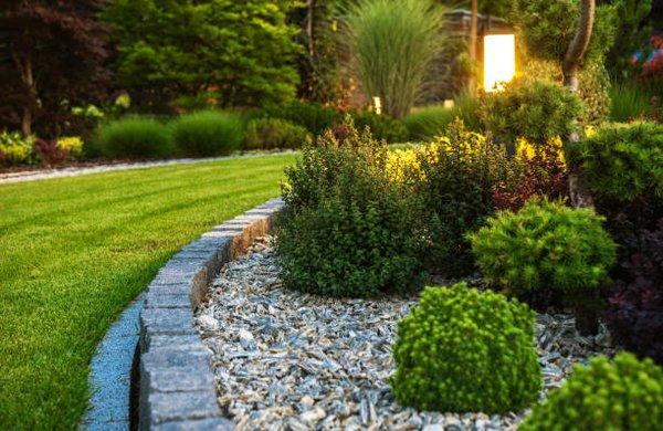 Block wall and landscape
Edge with shrubs and lighting