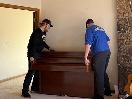 Connor and Blake literally smiling while moving grandma's piano