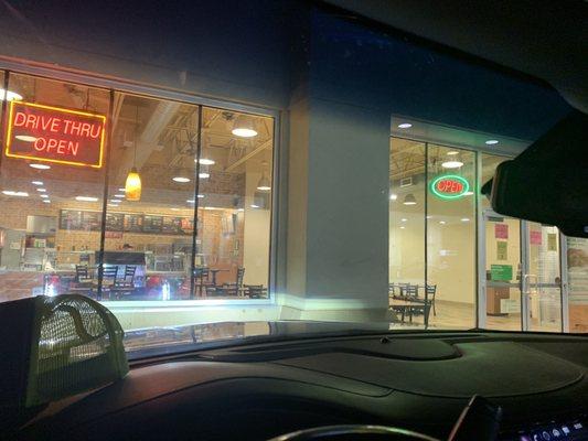 Drive thru and open signed both lit up and 3 workers inside