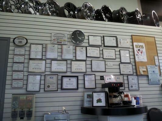 The employee certification awards on the wall