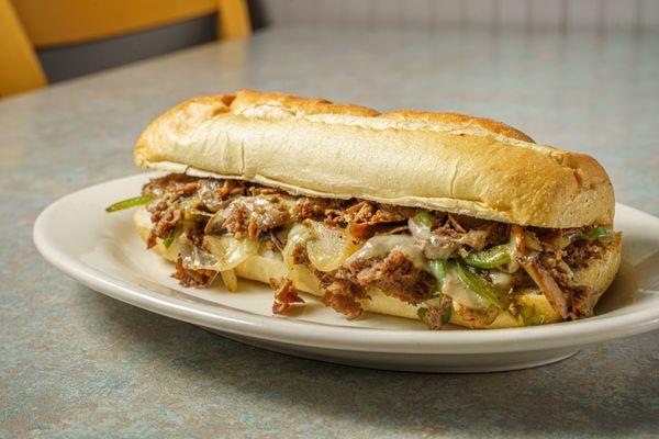 Shaved Grilled Steak and Provolone Cheese with Grilled Onions, Grilled  Mushrooms and Grilled Green Peppers. 
Toasted Bread.