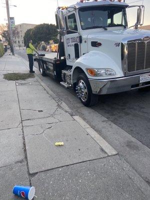 My tow truck driver fixing my spare