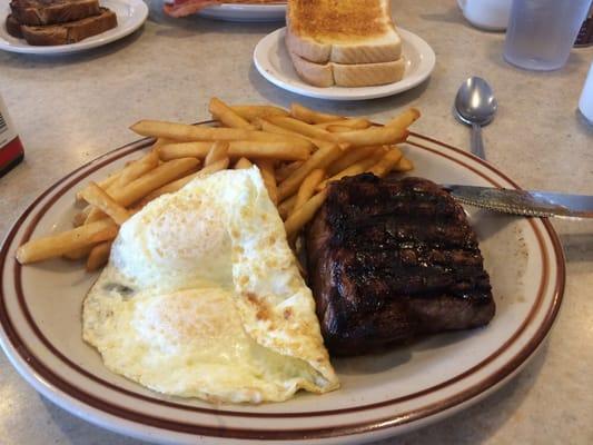 Steak and Eggs with fries as a hash brown substitute. Good size.