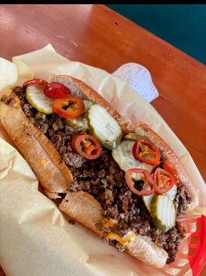 Cheese steak sandwich with pickles and jalapenos