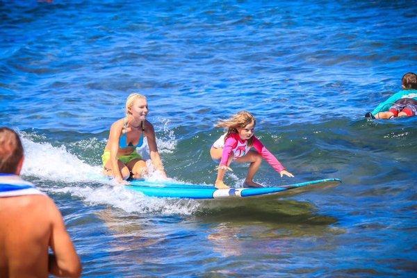 Instructor Lindsay tandem surfing with Kyra, age 6. This was her first time surfing. Book today call +1 (619) 972-7902 !