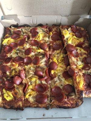 Half tray with pepperoni, mushrooms and banana peppers.