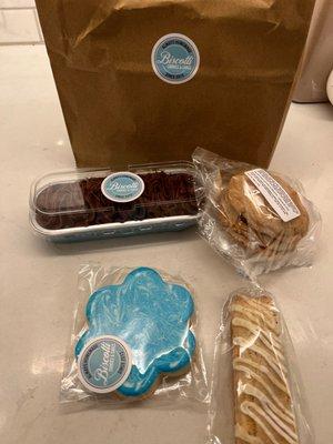 From top left-chocolate cake, peanut butter cookie with chocolate crème sandwich, lemon poppyseed biscotti, and lemon sugar cookie.