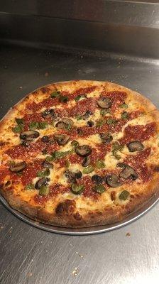 Upside down pizza with fresh mushrooms, green pepper and onions