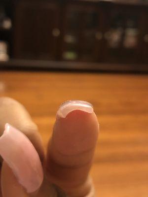 Nails is thick and one side has more acrylic than the other