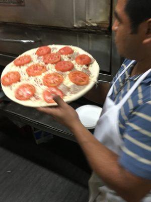 Getting Ready To Make A Fresh Pizza Pie For Delivery.