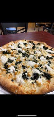 White pizza with spinach, chicken, and ricotta