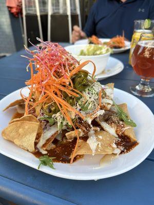 Special Nachos with shredded chicken Roja, pickled jalapeños, cabbage, beer cheese, julienned carrots, cotija cheese!