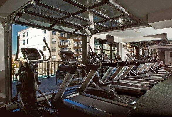 Our fitness room features glass garage style doors that open to enjoy the fresh air while you work out.