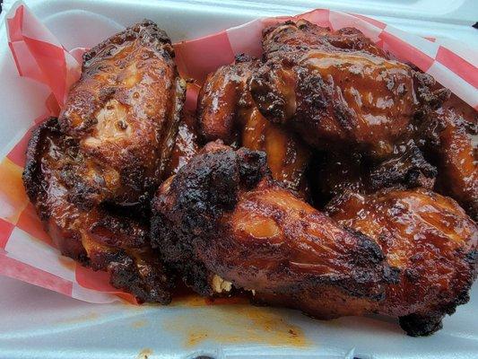 Smoked wings with hot sauce.