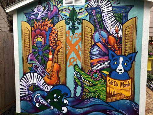 Mural Art in your yard, this client had a local artist paint a New Orleans themed mural, Art by Caroline Truong