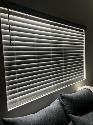 Living Room window blinds that can be turned the opposite way for a blackout effect.