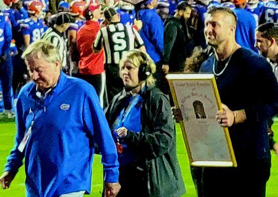 Tebow and Spurrier walked off the field after Tebow entered the College Football Hall of Fame during the game.