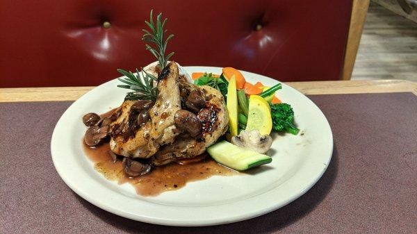 Two chicken breast dinner with veggies and red skin mashed potatoes and brown wine sauce with mushrooms.