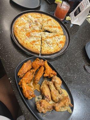 Buffalo chicken pizza, garlic parmesan wings and mild buffalo wings.