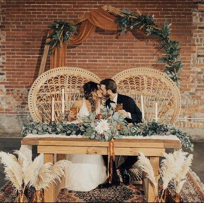 Our Genevieve Geometric Wedding Arch, our Daniela Peacock Chair set, and our vintage rug complete this look!